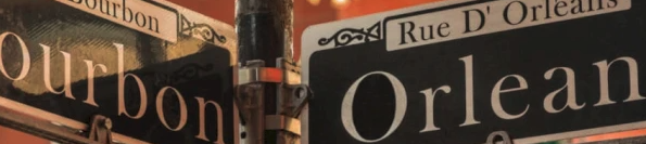 Street signs at a corner show &ldquo;Orleans&rdquo; and &ldquo;Bourbon&rdquo; in a lively downtown scene, with warm building colors and decorative lighting.