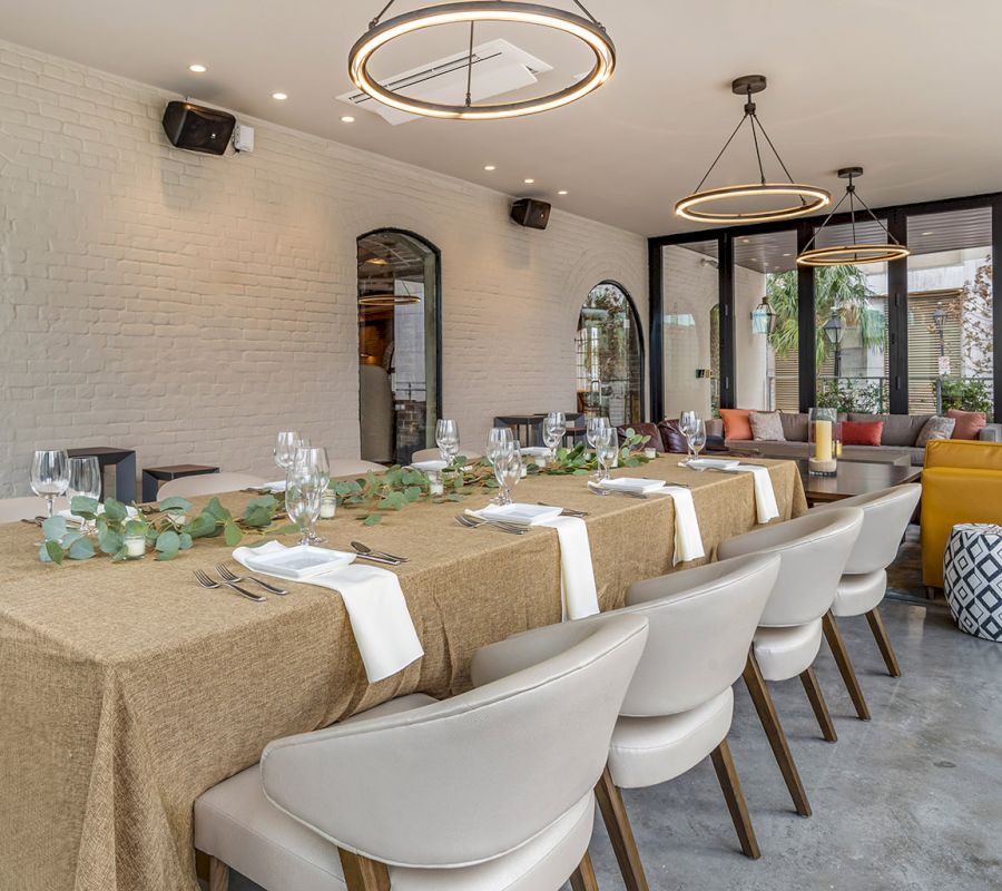 A dining area set with a long table, chairs, and decorative elements.